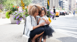 Working mom and daughter on city street